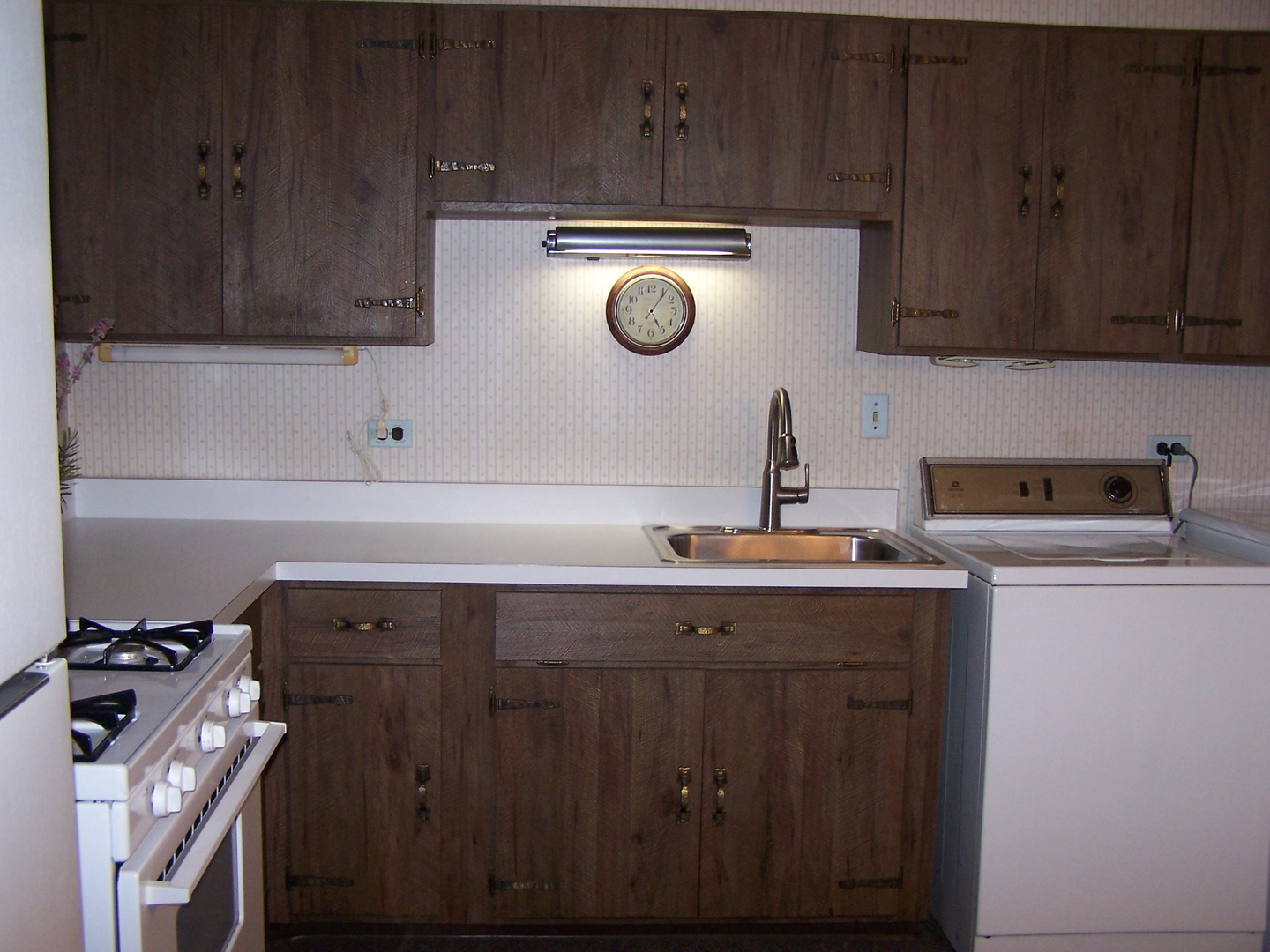 2404 School Drive Rolling Meadows, IL 60008 - Photo 8 of 14 a kitchen with a sink a stove and cabinets