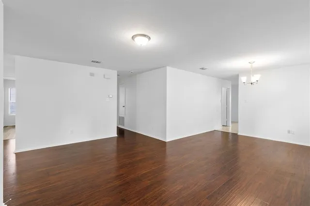 an empty room with wooden floor