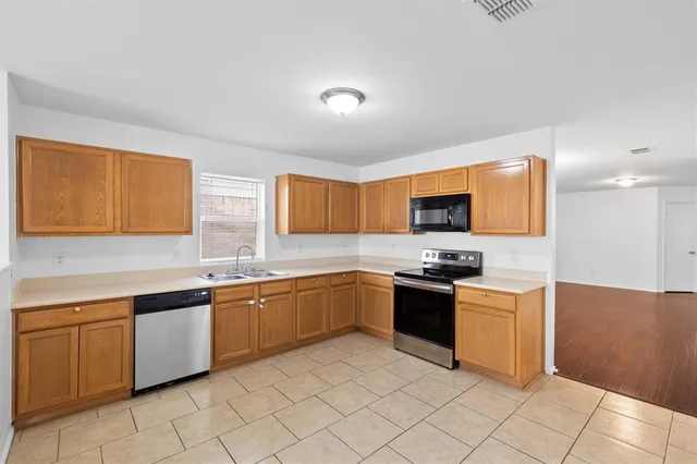 a kitchen with stainless steel appliances granite countertop a sink and cabinets