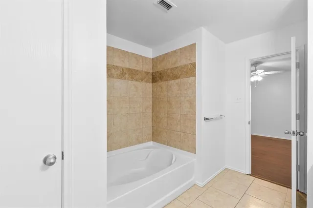 a bathroom with a bathtub and shower