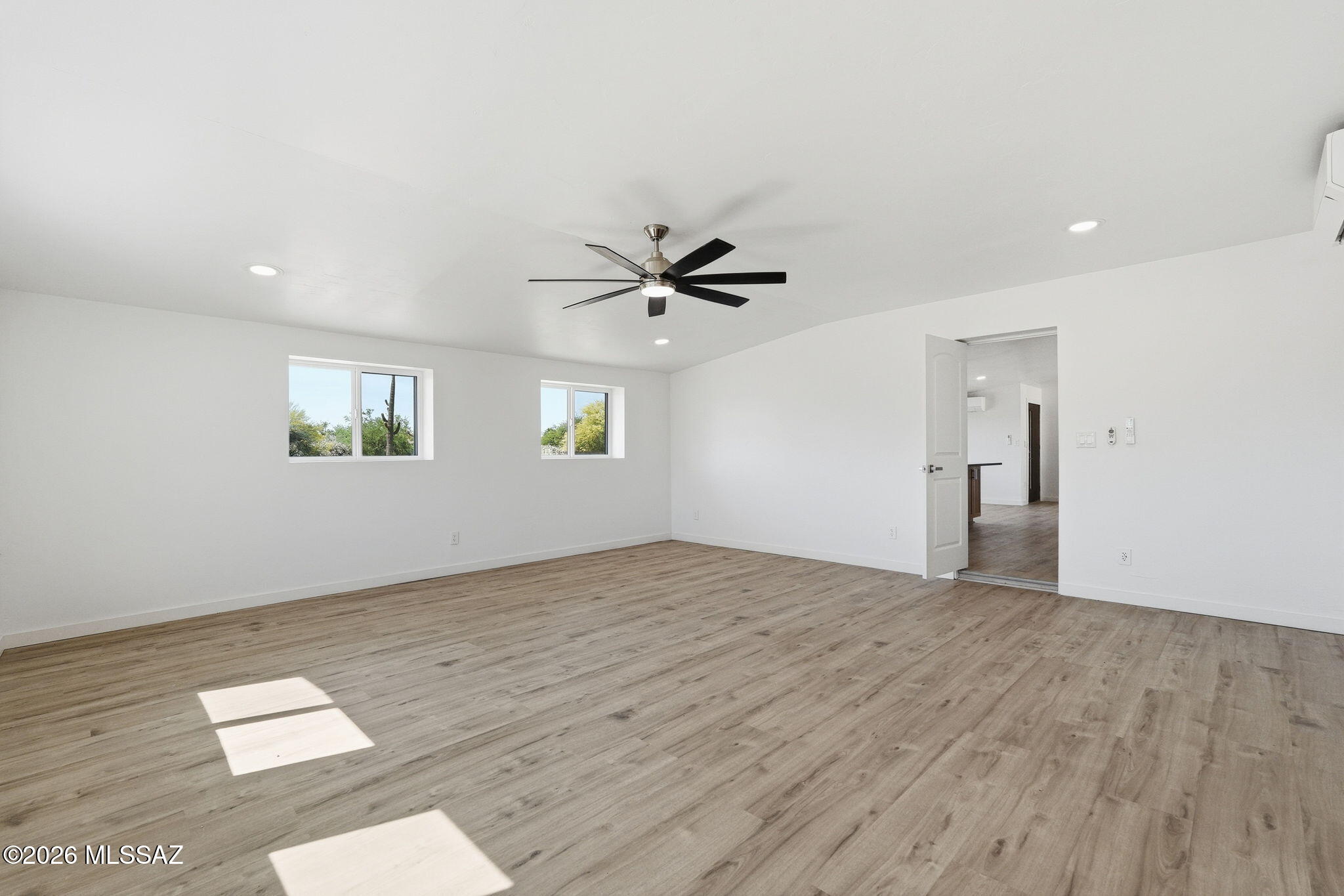 950 West Ina Road Tucson, AZ 85704 - Photo 18 of 54 an empty room with a window and a ceiling fan
