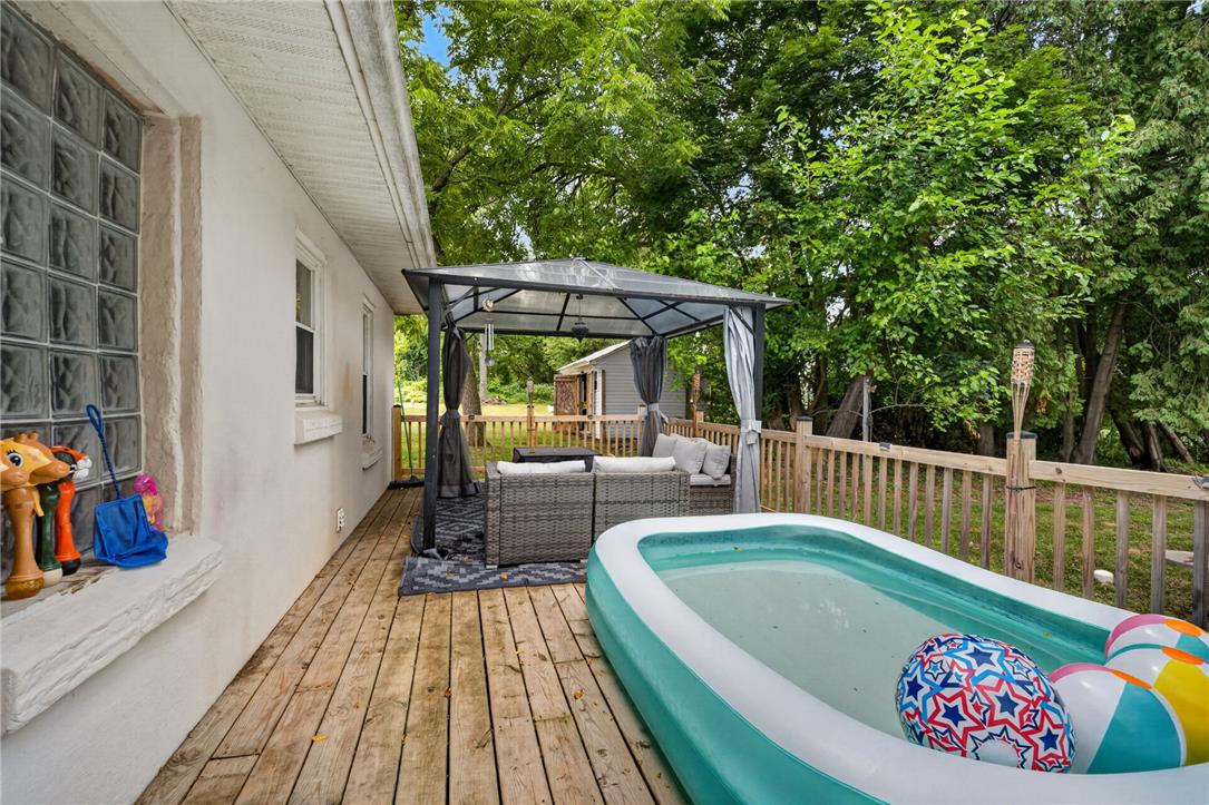 3123 Orefield Road Allentown, PA 18104 - Photo 11 of 39 A spacious wooden deck provides ample outdoor living space, featuring a cozy gazebo for shaded relaxation.