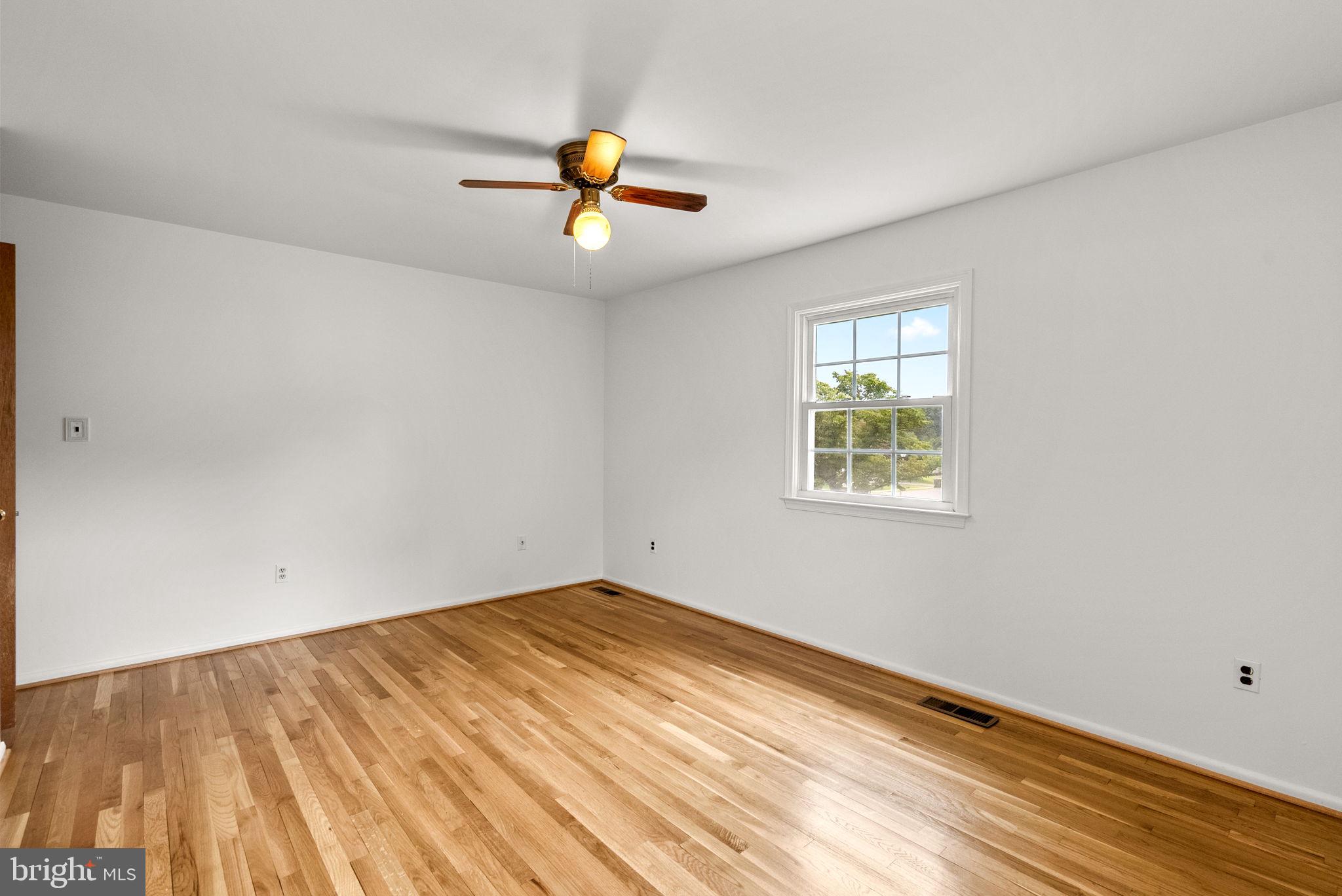 18724 Bloomfield Road Olney, MD 20832 - Photo 11 of 32 an empty room with wooden floor and window