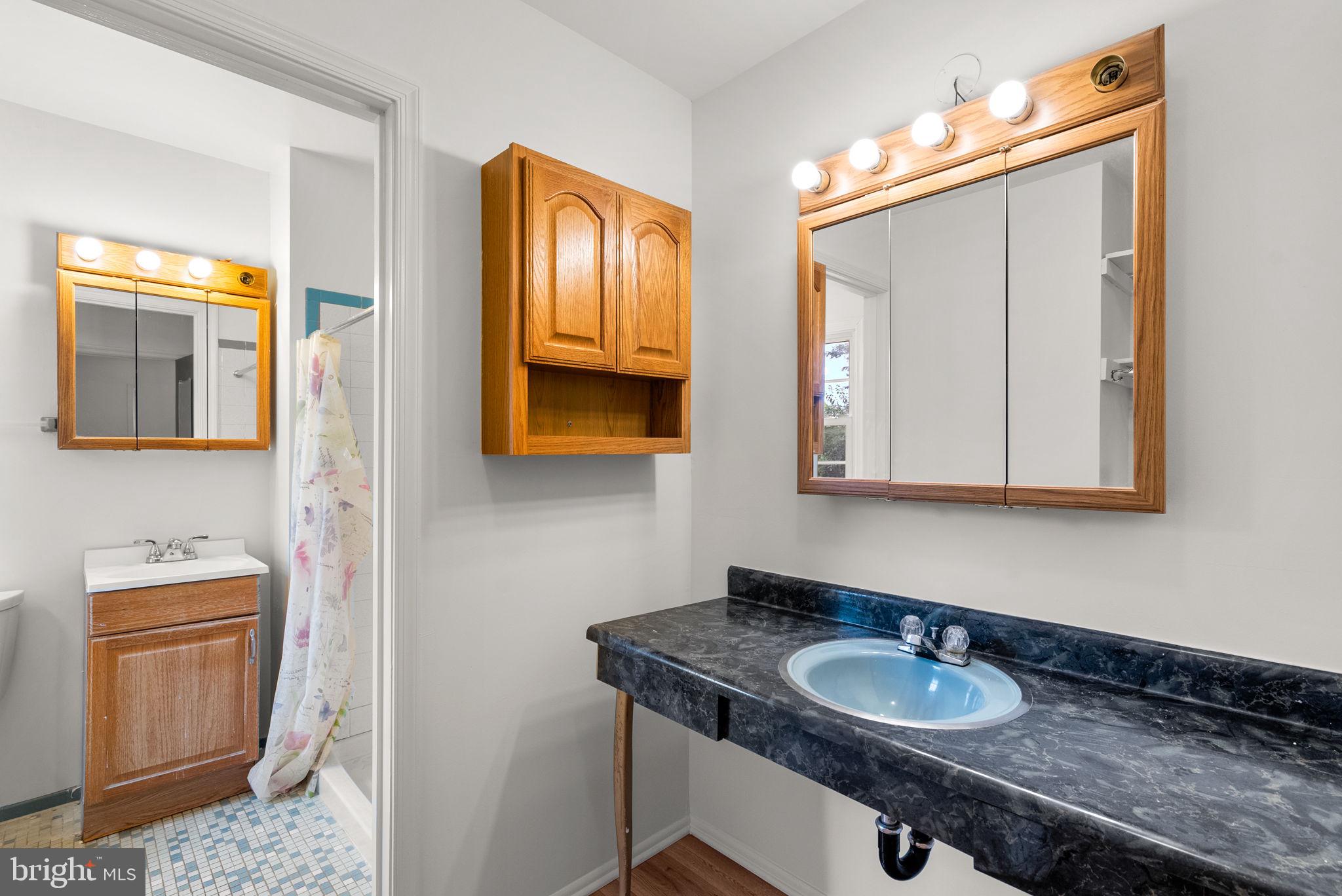 18724 Bloomfield Road Olney, MD 20832 - Photo 12 of 32 a bathroom with a granite countertop sink and a mirror