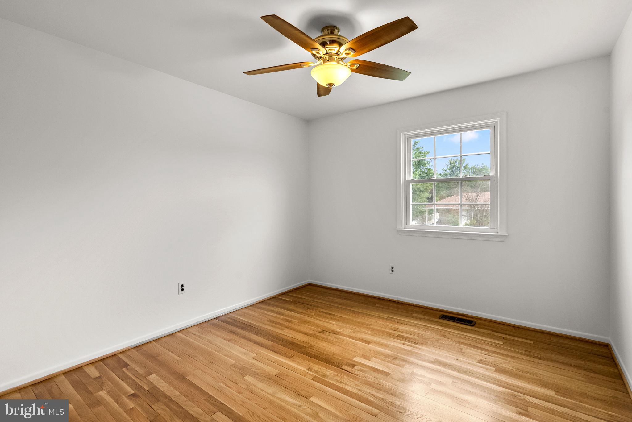18724 Bloomfield Road Olney, MD 20832 - Photo 17 of 32 an empty room with a window and a ceiling fan