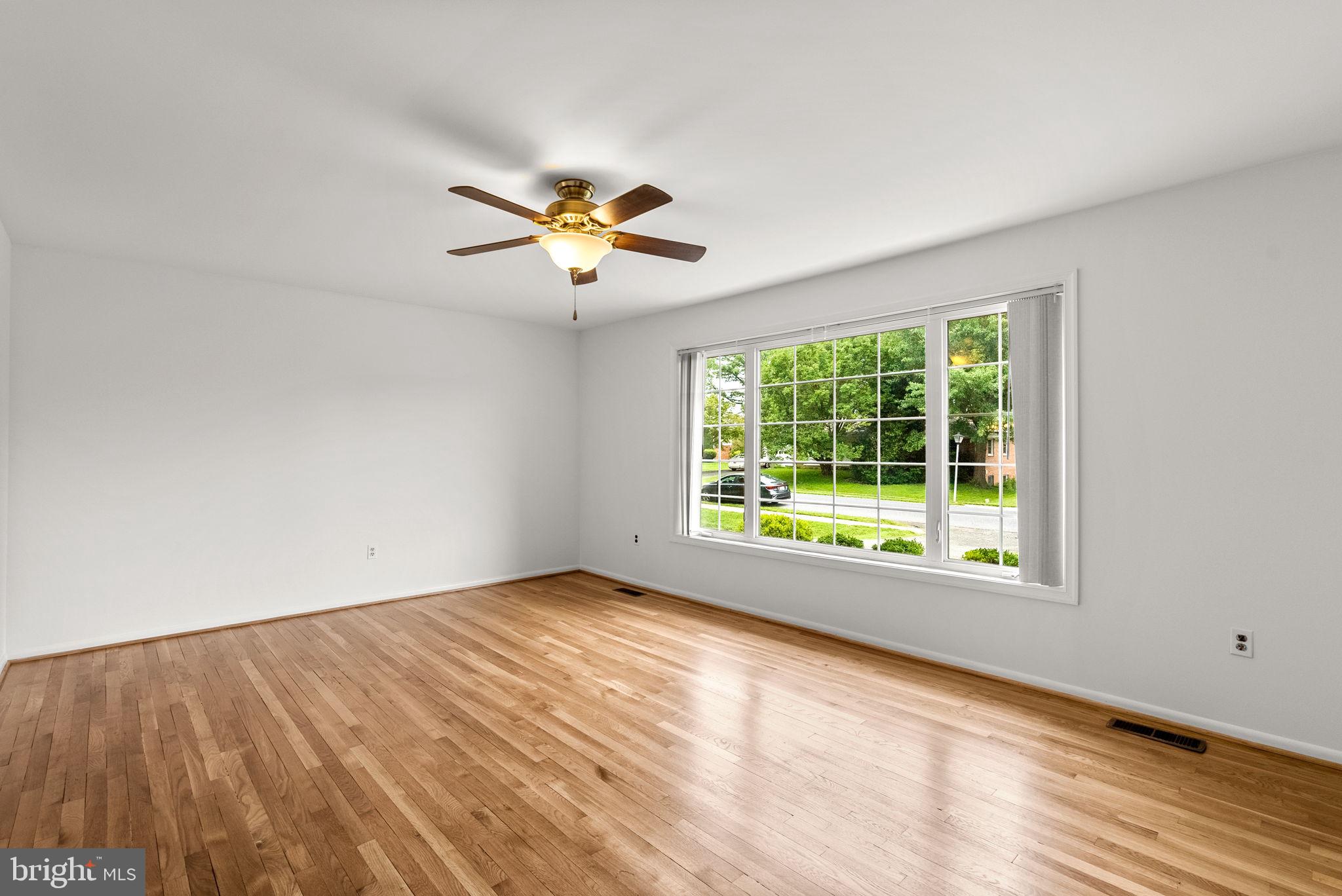 18724 Bloomfield Road Olney, MD 20832 - Photo 2 of 32 a view of an empty room with a window and a ceiling fan