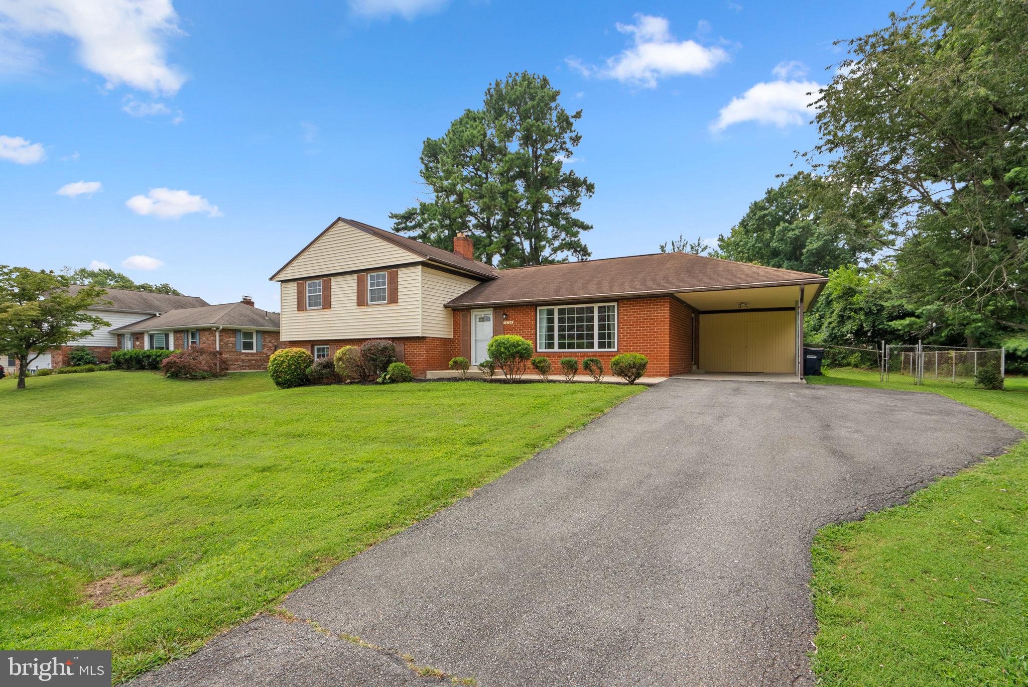 18724 Bloomfield Road Olney, MD 20832 - Photo 29 of 32 a front view of a house with a garden and yard