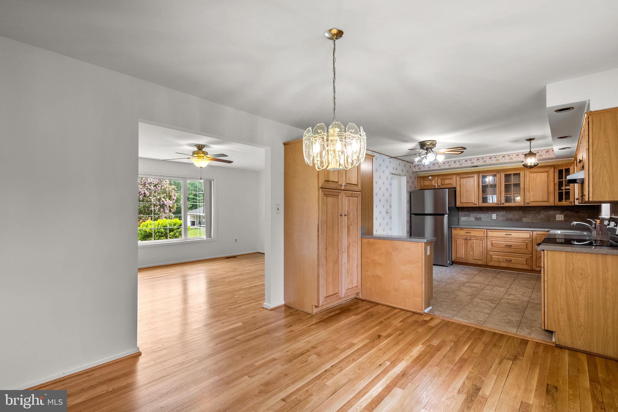 18724 Bloomfield Road Olney, MD 20832 - Photo 5 of 32 a view of a room with wooden floor kitchen chandelier and windows