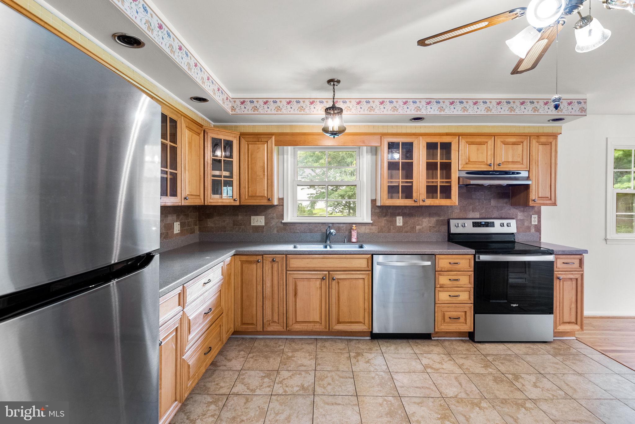 18724 Bloomfield Road Olney, MD 20832 - Photo 7 of 32 a large kitchen with stainless steel appliances granite countertop a sink and cabinets
