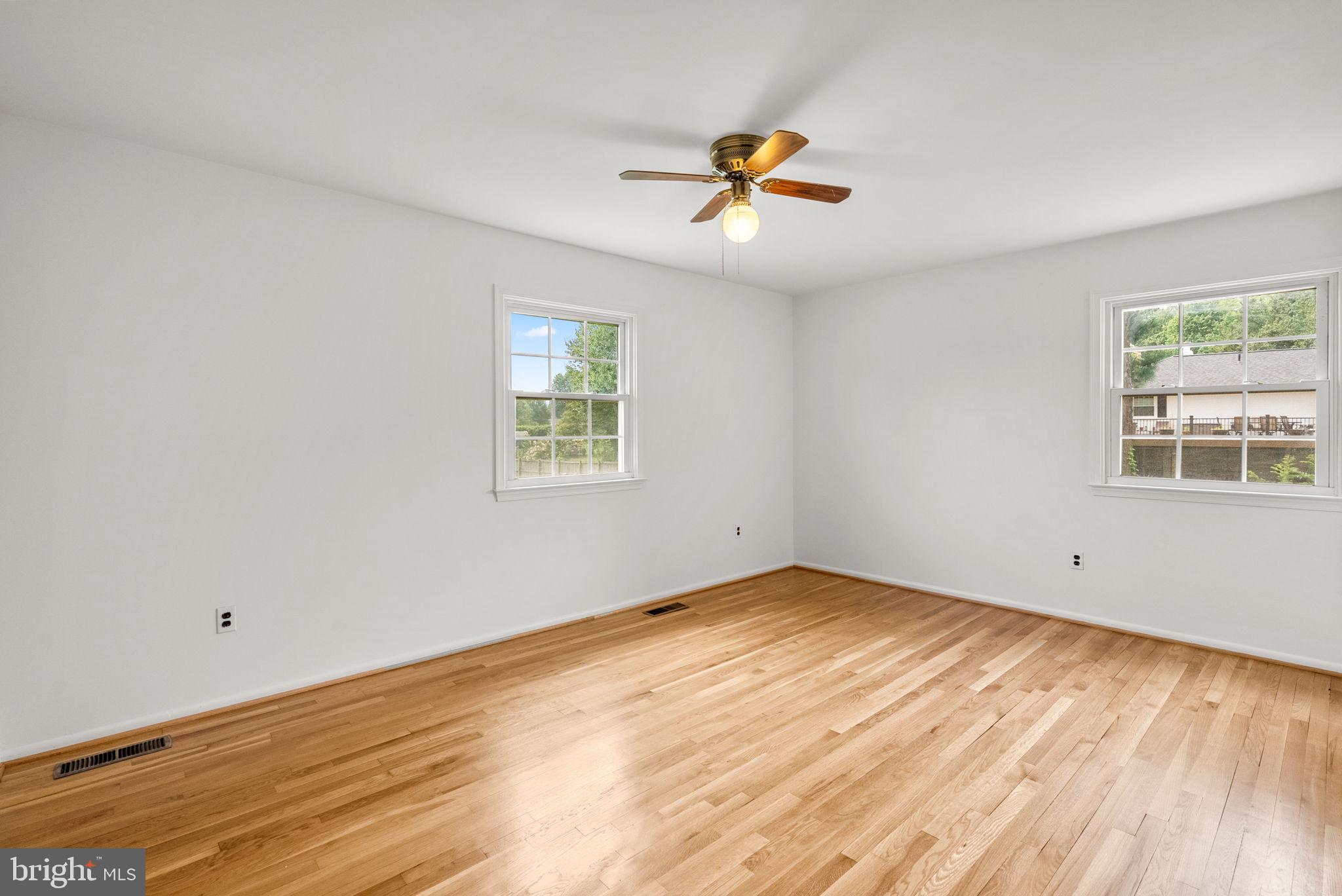 18724 Bloomfield Road Olney, MD 20832 - Photo 9 of 32 a view of empty room with wooden floor and fan