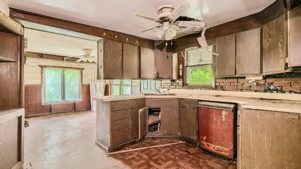 a kitchen with a sink appliances and cabinets