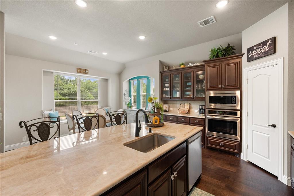 445 Rusty Run Drive Midlothian, TX 76065 - Photo 18 of 40 a kitchen with counter top space a sink and appliances