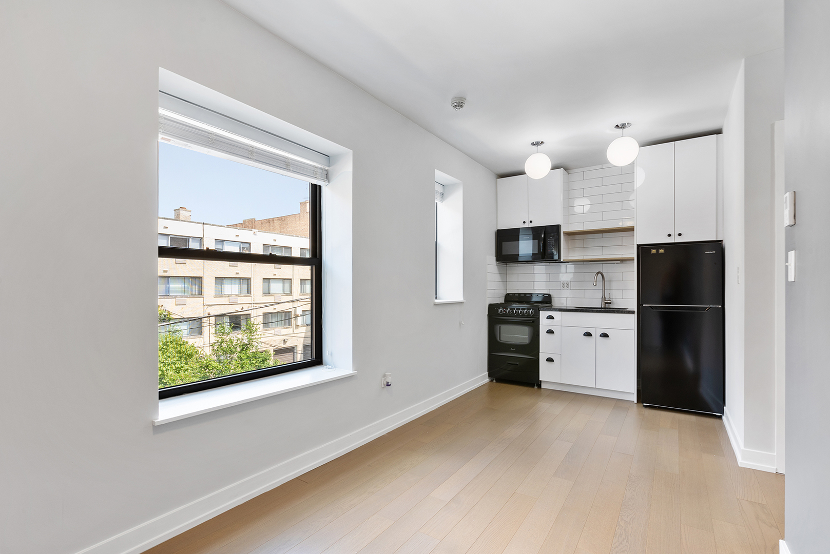 6019 North Winthrop Avenue, Unit 314 Chicago, IL 60660 - Photo 2 of 14 a kitchen with stainless steel appliances a refrigerator a stove a sink and a window