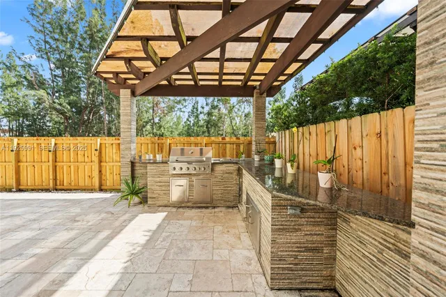 a bathroom with a sink a mirror and next to a yard