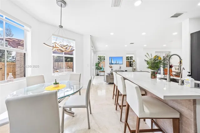 a view of living room with furniture and a potted plant