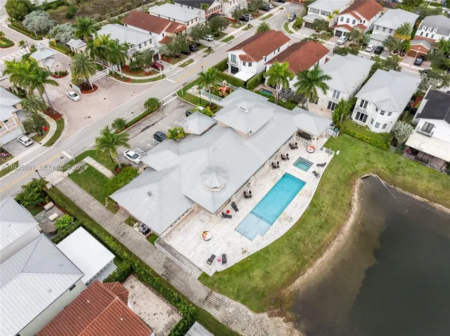 an aerial view of a house with a garden and lake view