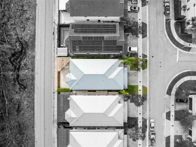 an aerial view of a house with swimming pool and sitting space
