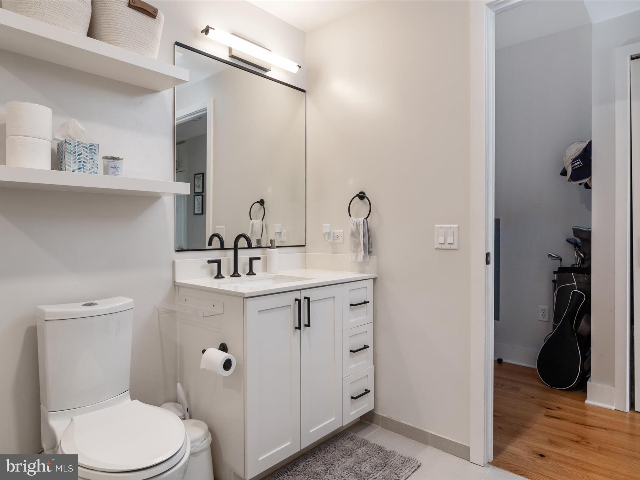 1211 Van Street Southeast, Unit 1110 Washington, DC 20003 - Photo 30 of 46 a bathroom with a sink a toilet and a mirror