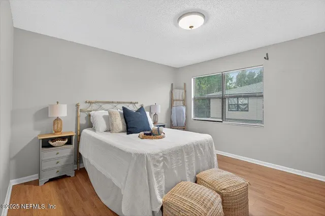 a bedroom with a bed and a night stand