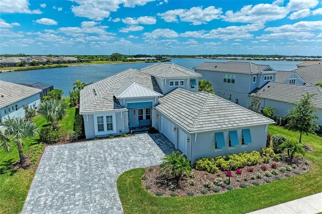 an aerial view of a house with garden space and a patio