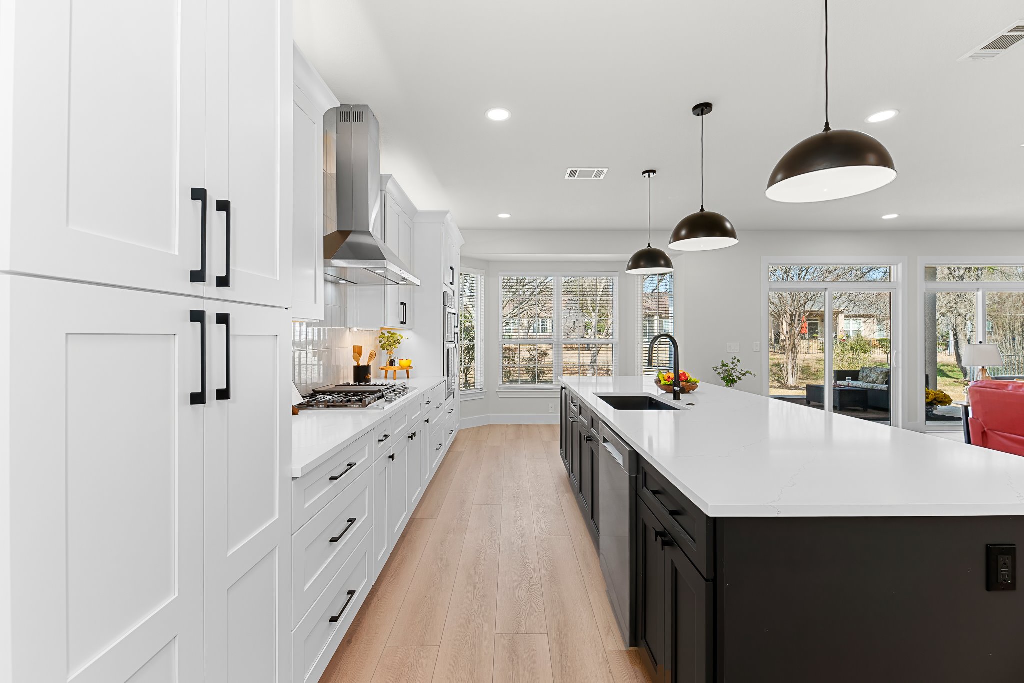 206 Armstrong Drive Georgetown, TX 78633 - Photo 25 of 39 a large kitchen with stainless steel appliances a large counter top a stove a chimney a sink and a refrigerator