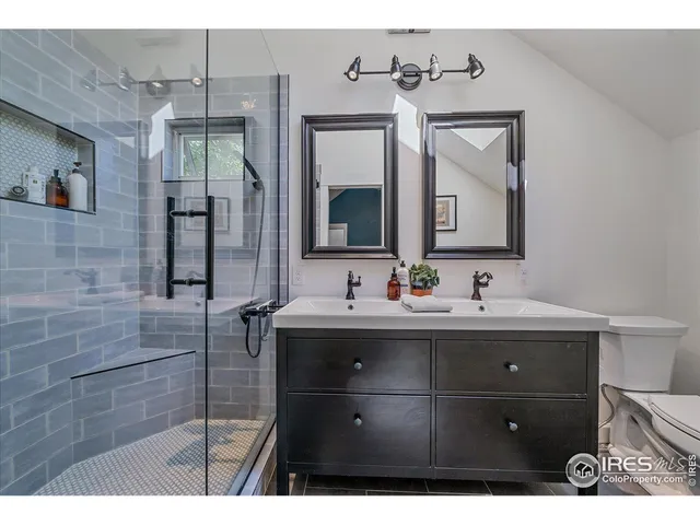 a bathroom with a sink vanity and mirror