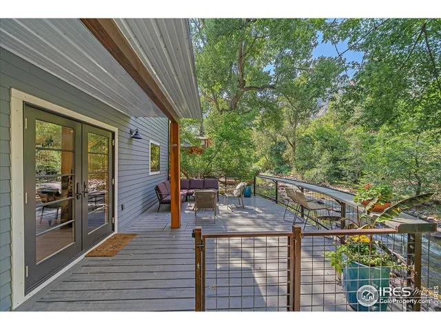 a view of a patio with table and chairs with wooden floor