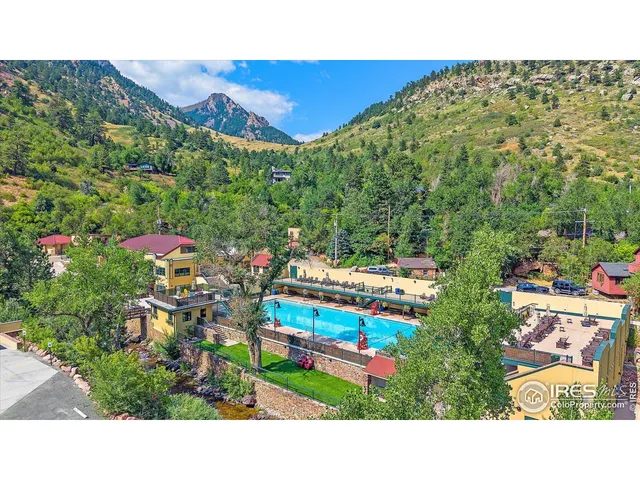 a view of a chairs and table in a backyard