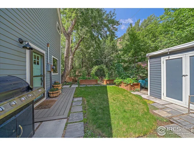 a view of backyard of house with green space