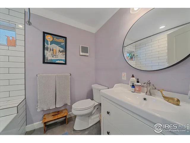 a bathroom with a sink mirror and toilet