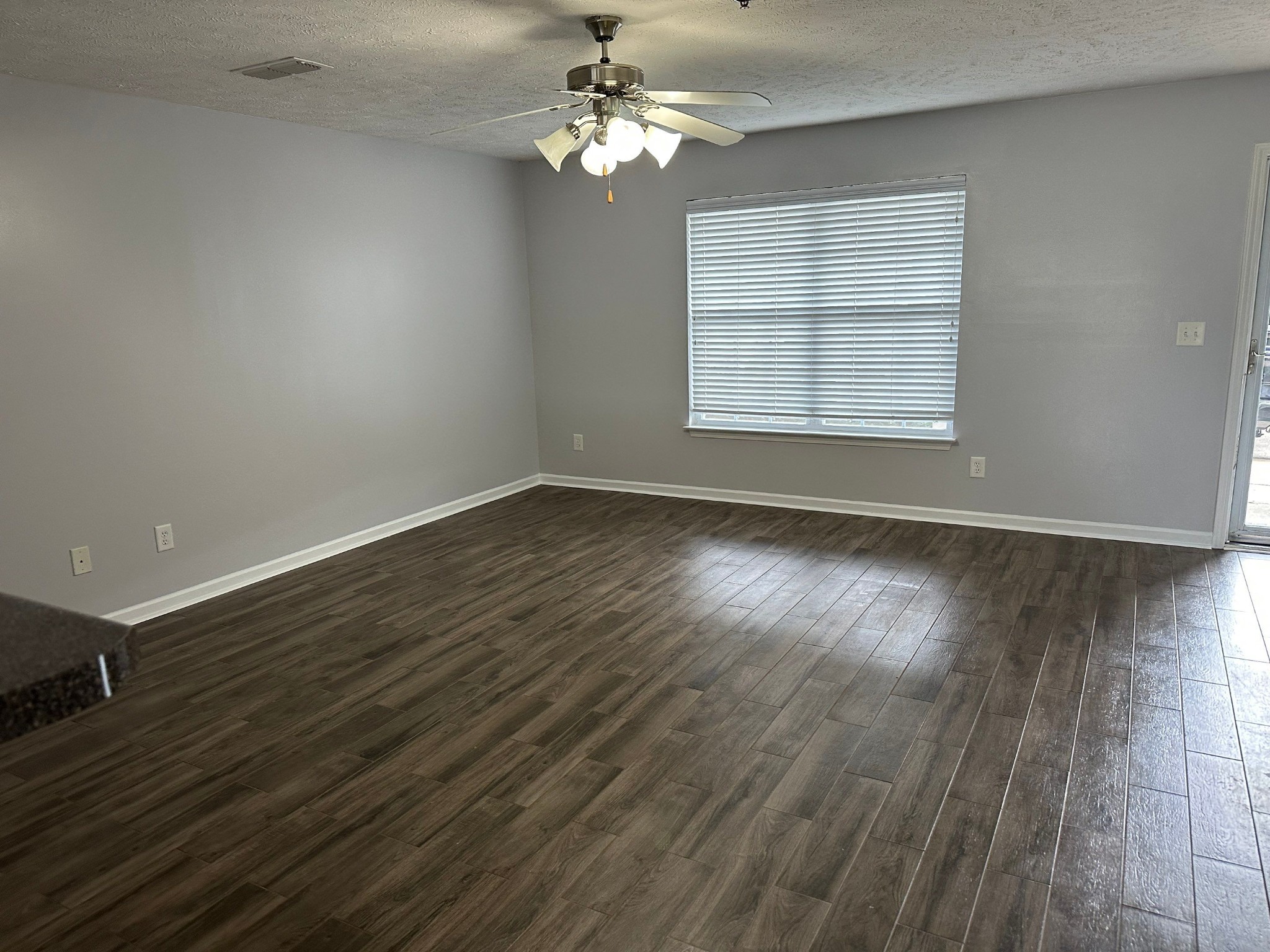 4020 Pavati Trace Spring Hill, TN 37174 - Photo 5 of 19 an empty room with wooden floor chandelier fan and windows