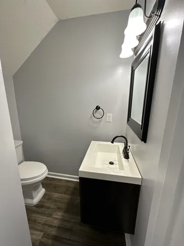 a bathroom with a sink toilet and mirror