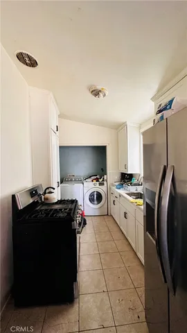 a kitchen with a stove a refrigerator and a sink