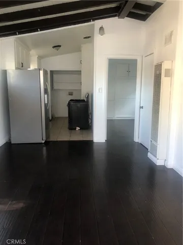 a view of a refrigerator in kitchen and wooden floor