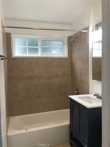 a bathroom with a sink mirror toilet and bathtub