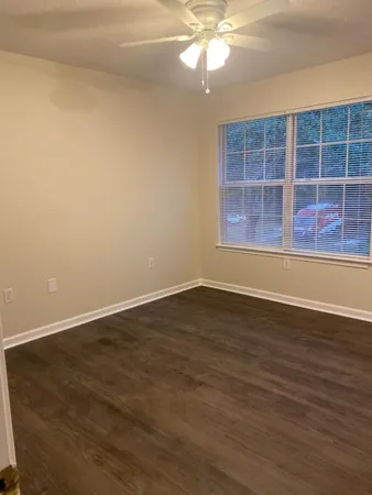 a view of wooden floor and windows in a room