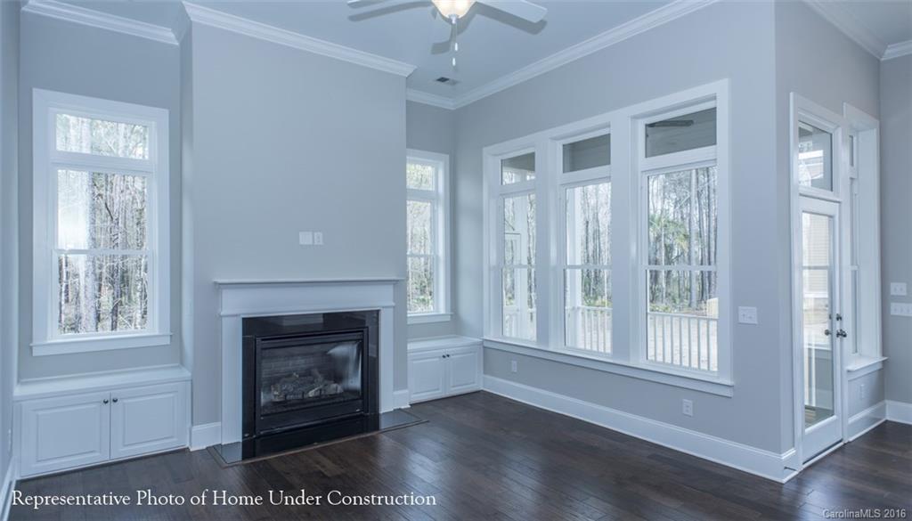 5219 Meadowcroft Way, Unit 149 Fort Mill, SC 29708 - Photo 2 of 7 a view of an empty room with wooden floor fireplace and a window