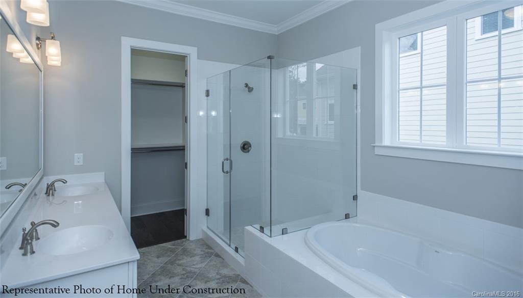 5219 Meadowcroft Way, Unit 149 Fort Mill, SC 29708 - Photo 6 of 7 a bathroom with a tub shower sink and mirror