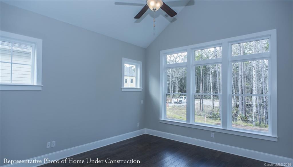 5219 Meadowcroft Way, Unit 149 Fort Mill, SC 29708 - Photo 7 of 7 a view of an empty room with a window and wooden floor