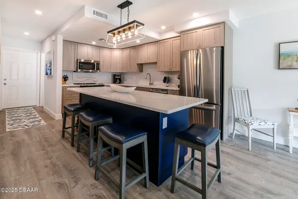 a large kitchen with a table and chairs