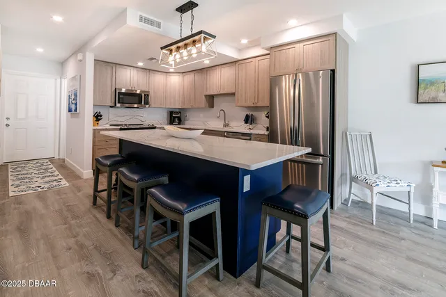 a large kitchen with a table and chairs