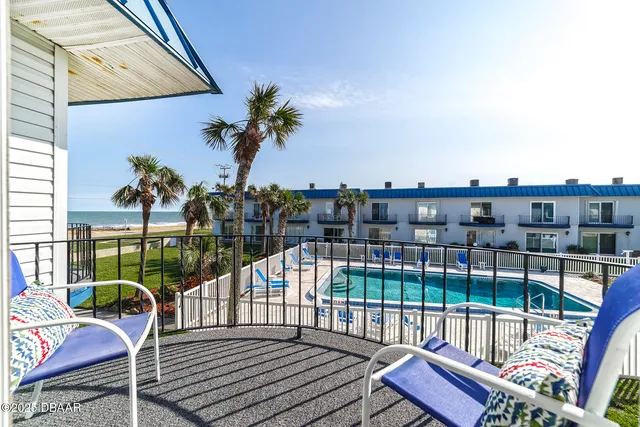 a view of a balcony with wooden floor