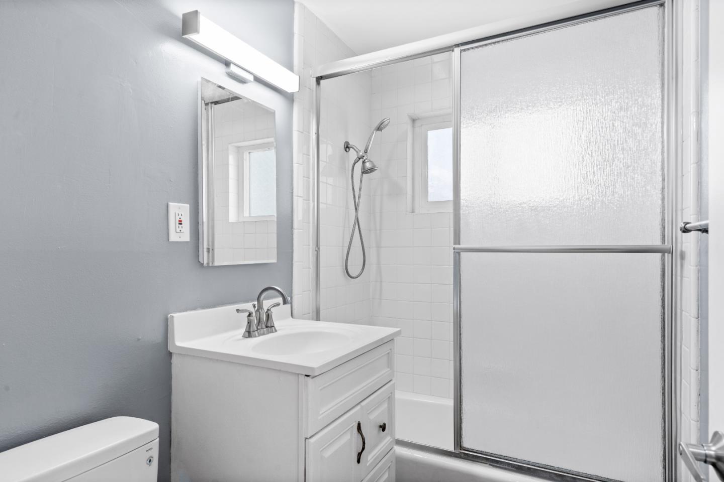 4 Coleman Place Menlo Park, CA 94025 - Photo 15 of 34 a bathroom with a shower sink vanity and mirror