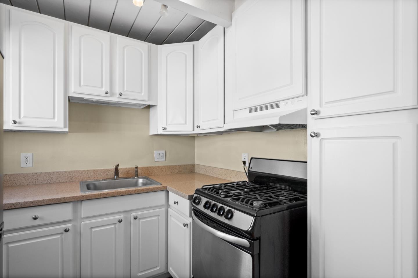 4 Coleman Place Menlo Park, CA 94025 - Photo 30 of 34 a kitchen with stainless steel appliances granite countertop white cabinets and a stove top oven