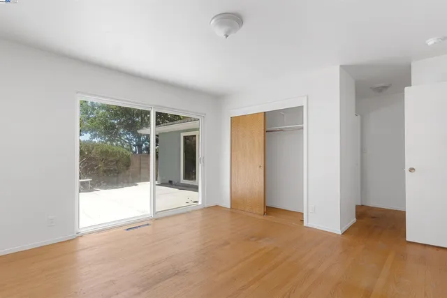 a view of an empty room with glass door