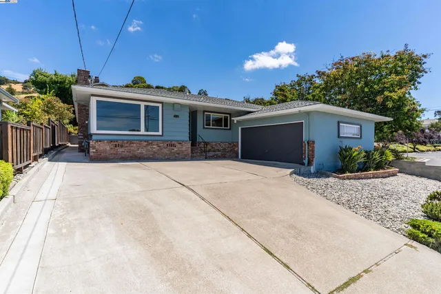 a front view of a house with a yard and a garage