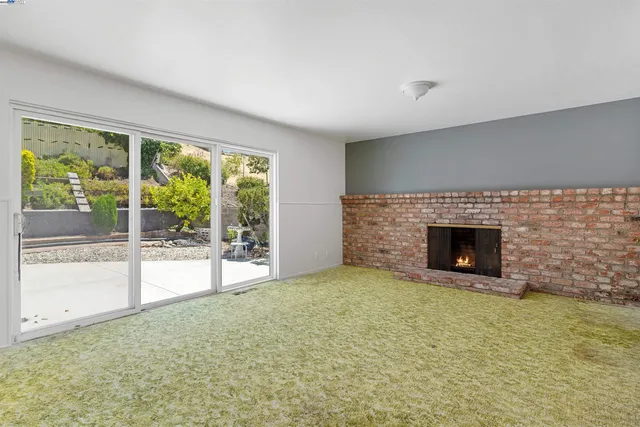 a view of an empty room with a fireplace