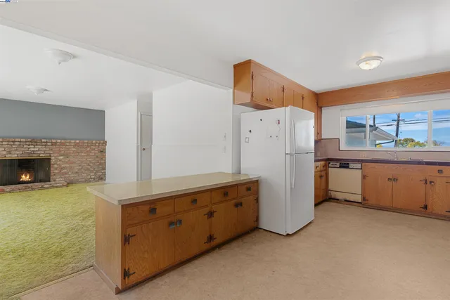 a kitchen with a refrigerator and a stove