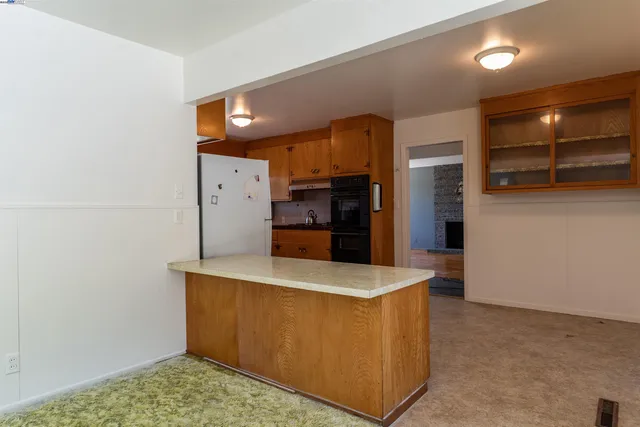 a view of a kitchen counter space and stainless steel appliances