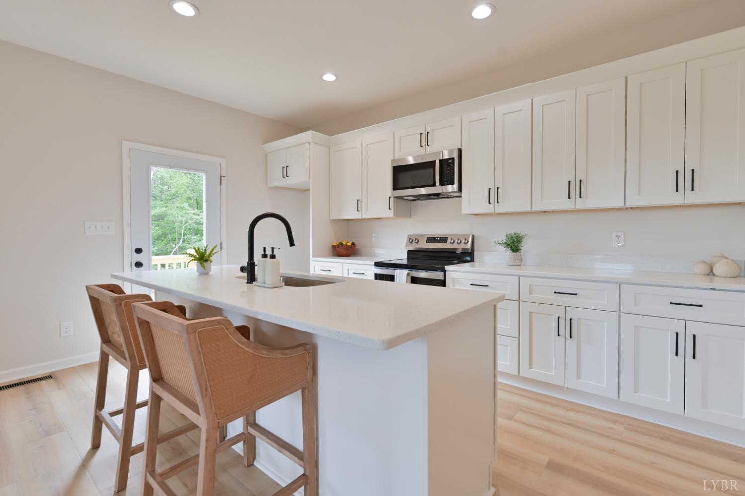 1843 Crockett Road Forest, VA 24551 - Photo 3 of 32 Open Concept kitchen with quartz counters, oversized island, door to deck, etc *Fridge ordered and scheduled to be installed.
